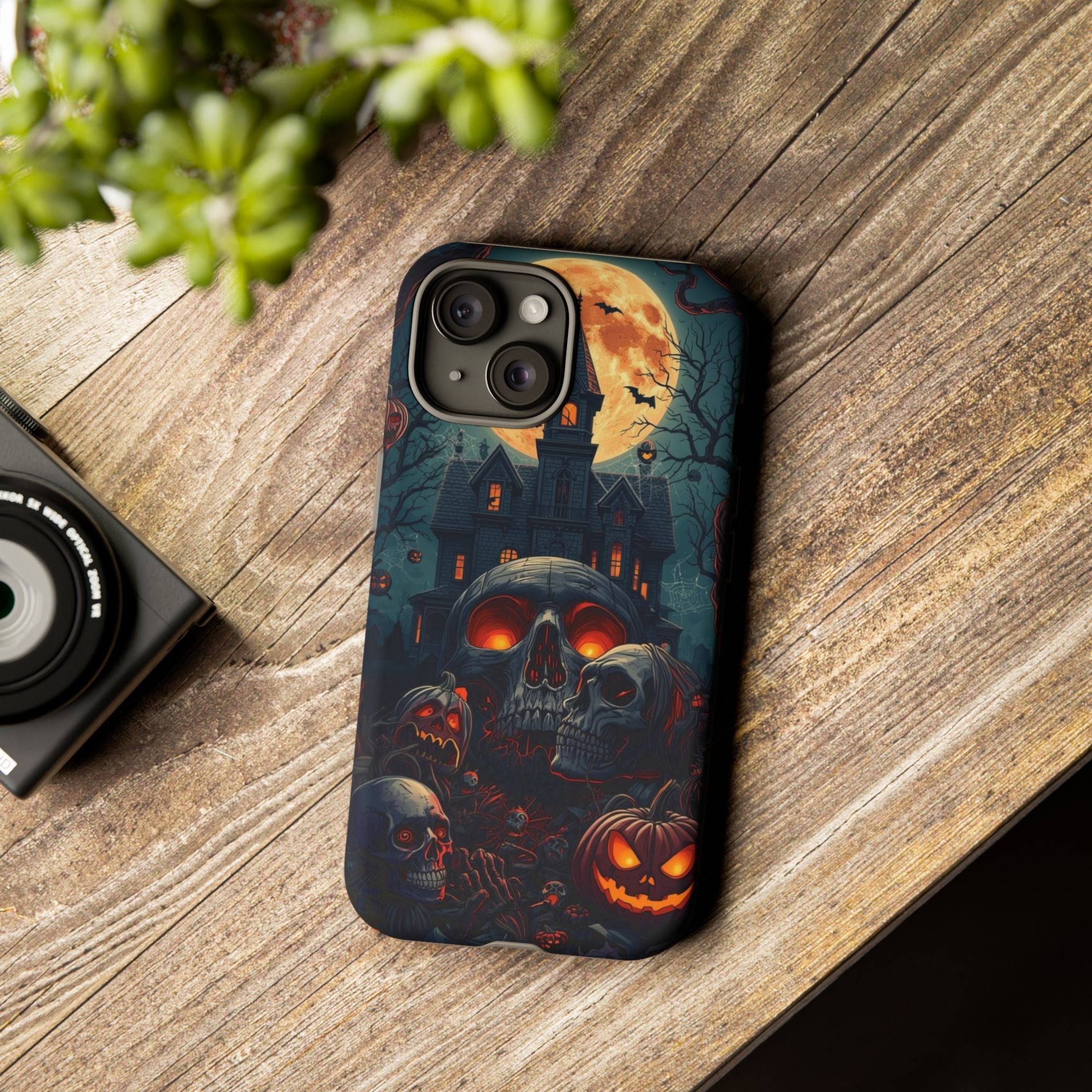 Spooky Halloween Phone Case with Skulls, Pumpkins, and Haunted Mansion